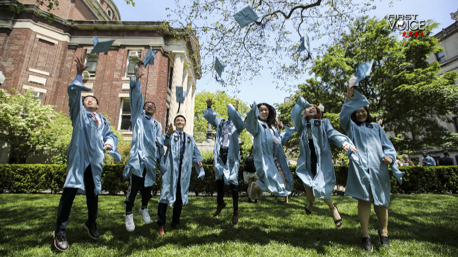 Graduate students from China pose for photos on campus after the Columbia University Commencement ceremony in New York, the United States, May 22, 2019. /Xinhua